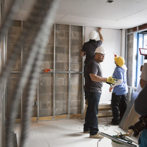 Contractors working on house interior
