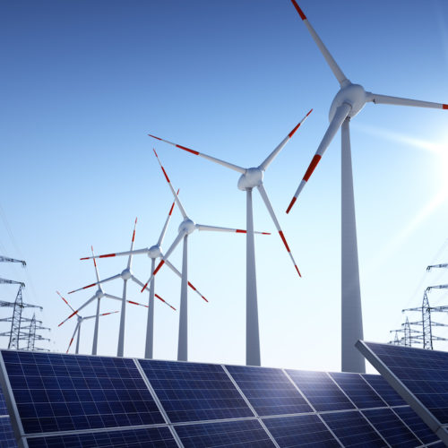 Electrical poles of high voltage and wind turbines in blue sky