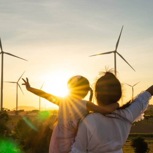 wind farm with silhouette of people