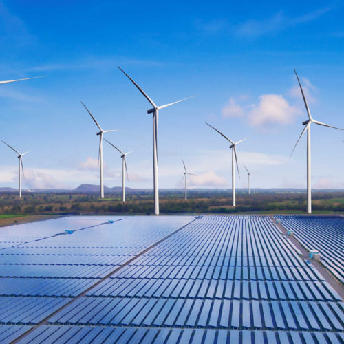 Solar energy panel photovoltaic cell and wind turbine farm power generator in nature landscape for production of renewable green energy is friendly industry.